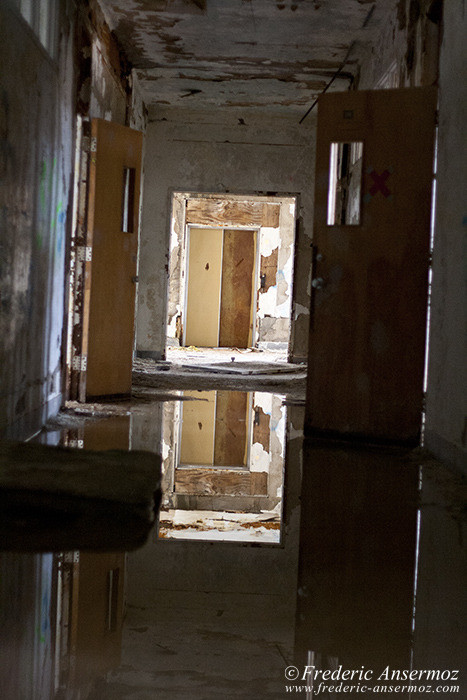 Swamped corridor, abandoned asylum, Ste Clotilde de Horton