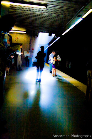 Boston Subway picture of woman in sunlight from ceiling