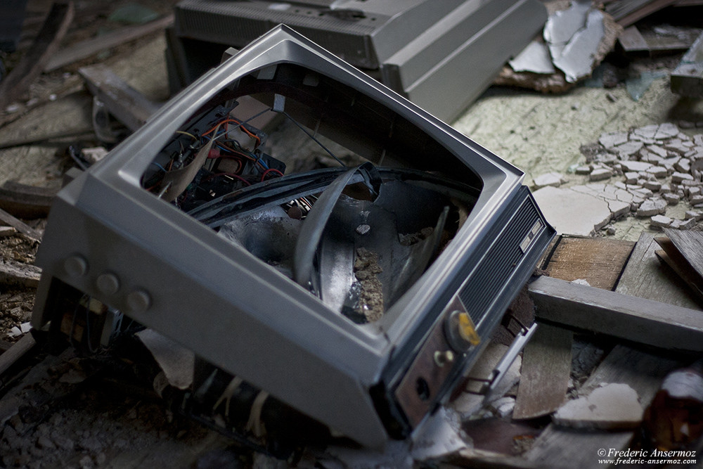 Broken television with trash and debris